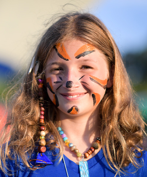 Girl with face painted like an animal