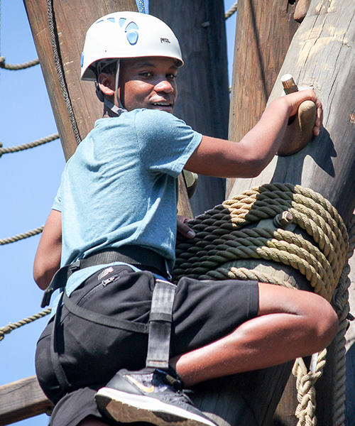 Boy climbing adventure tower