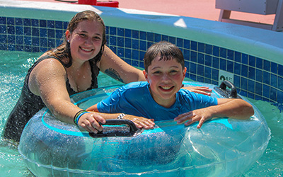 Counselor with camper in swimming pool
