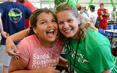 Camper and counselor smiling