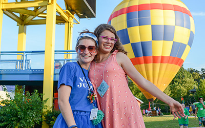 Counselor and camper in front of hot air balloon