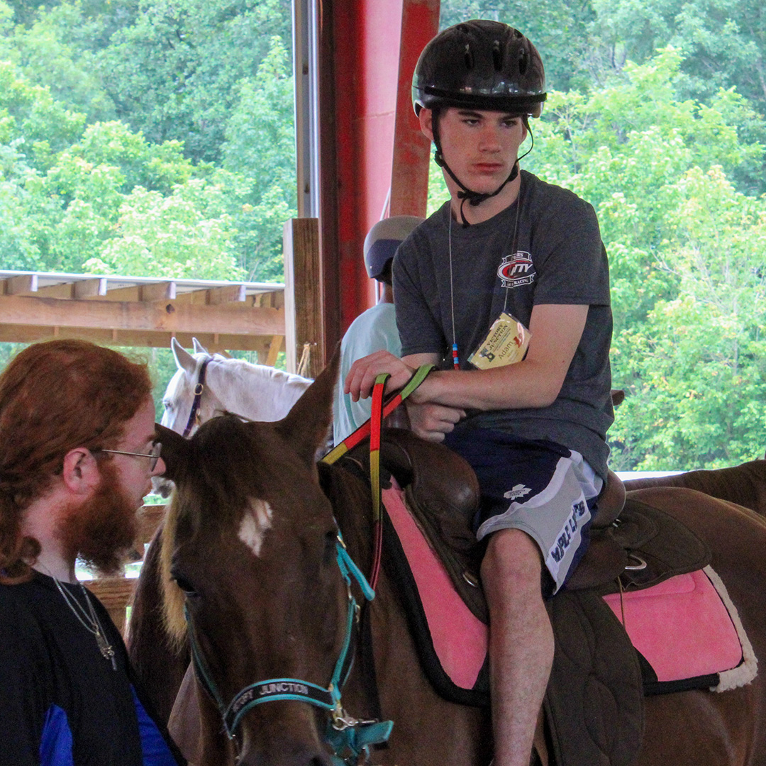 Adam riding a horse