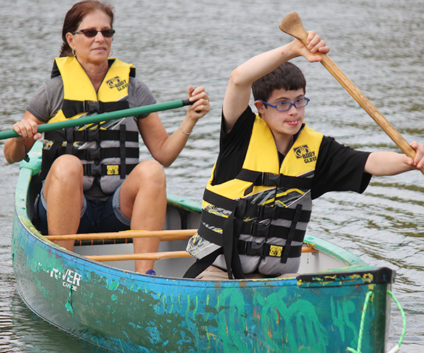 Mother and son paddling canoe
