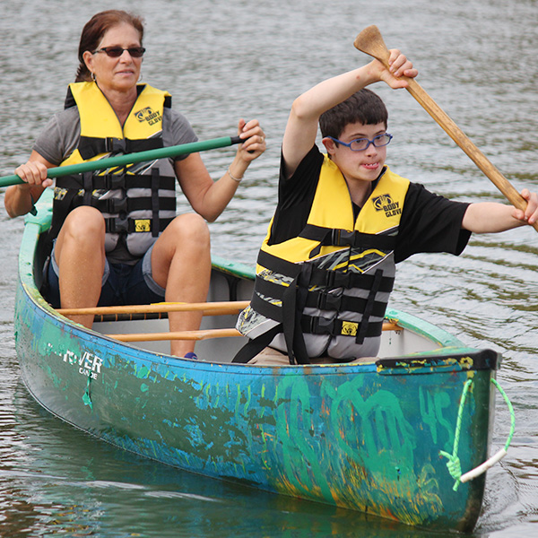 Mother and son paddling canoe