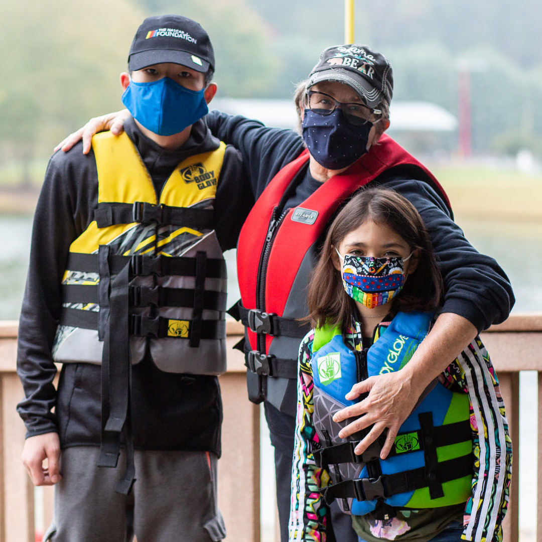 Family at fishing dock wearing face masks