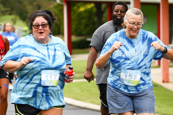 Two women running and smiling