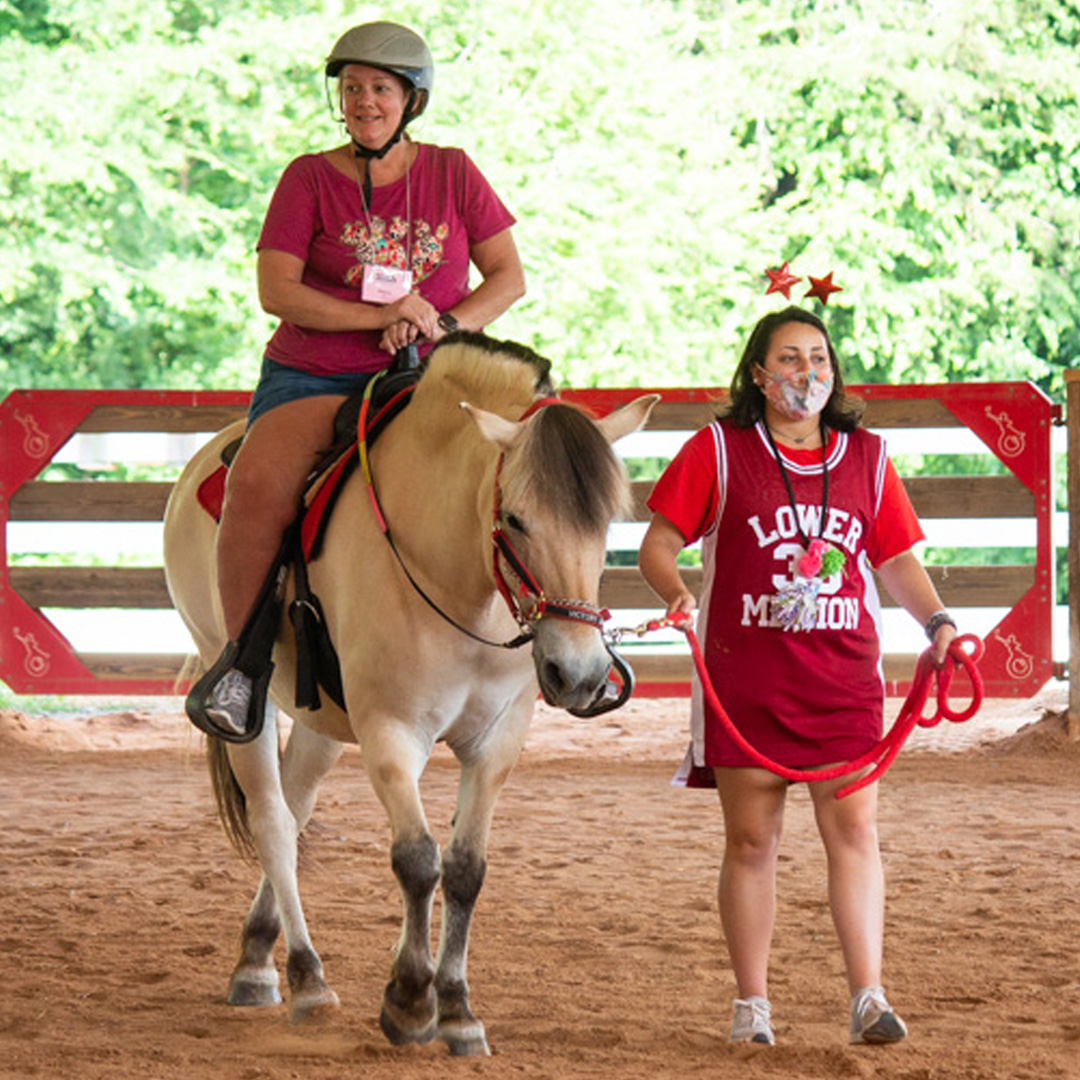 Lauren leading a parent riding a horse
