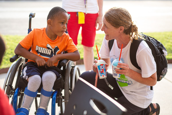 Counselor talking to boy in wheelchair