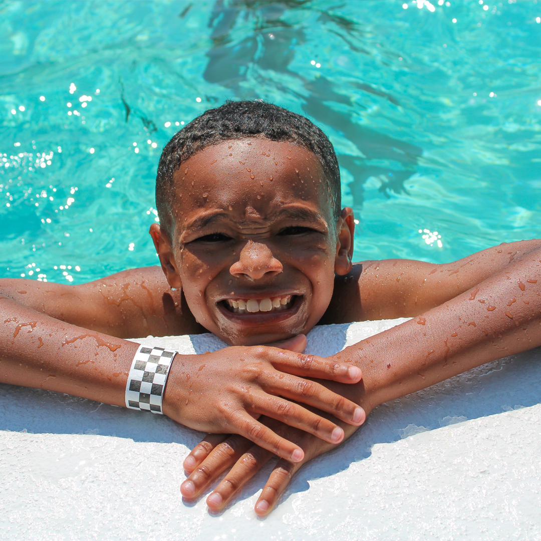 Boy in swimming pool smiling.