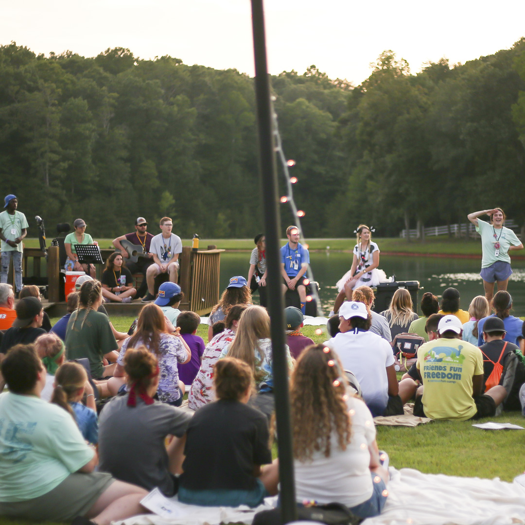 Campers and staff gather for the closing campfire after a summer session.