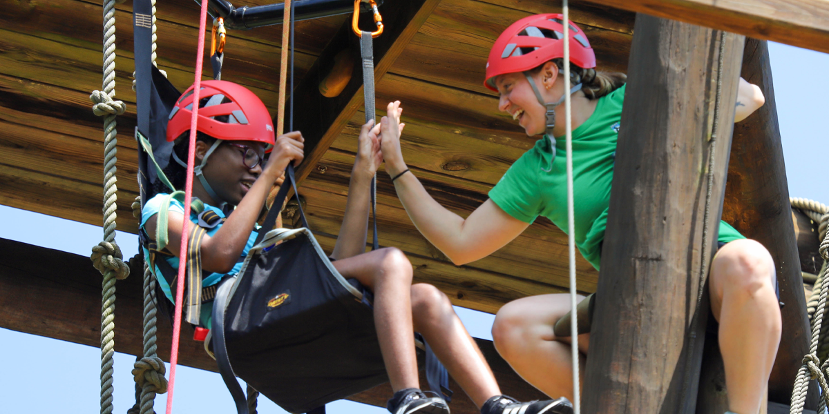 About Image 4 1200x600 Camper and counselor on climbing tower