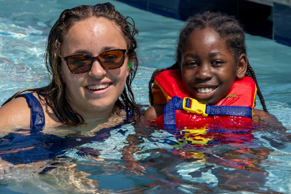 Counselor and camper in the pool