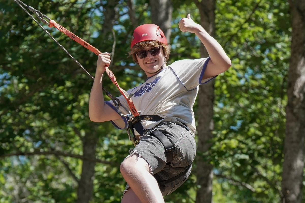 Camper enjoying the adventure swing at Victory Junction, made possible through donor support.