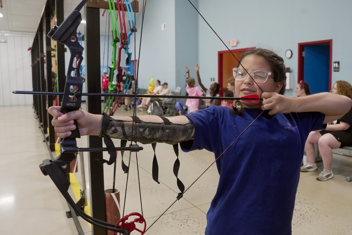 Camper participating in adaptive archery at Victory Junction.